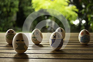 Funny eggs with human faces. Eggs wearing face masks or colored chinstraps. Selective focus. Chinstrap in white eggs