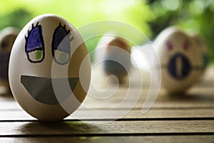 Funny eggs with human faces. Eggs wearing face masks or colored chinstraps. Selective focus. Chinstrap in white eggs