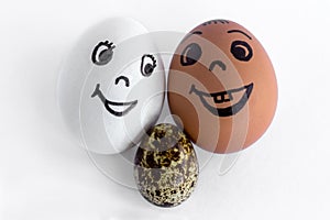 Funny eggs imitating a smiling mixed couple with versicolored ba photo