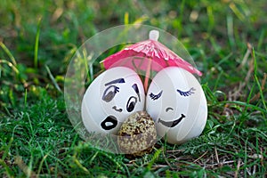 Funny eggs imitating white mother and father with versicolored b photo