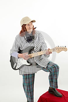 Funny elderly lady playing electric guitar