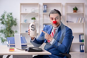 Funny employee clown working in the office