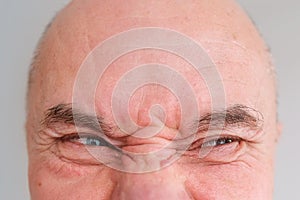 Funny face of european adult man close up, wrinkles on aging skin, actor`s grimaces, human emotions, mental illness