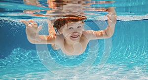 Funny face portrait of child boy swimming and diving underwater with fun in pool.