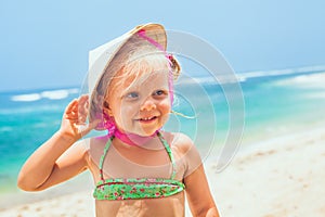 Funny face portrait of happy child in vietnamese straw hat