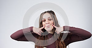 Funny, face and portrait of woman with humor, joke or goofy expression isolated in a studio white background. Comic