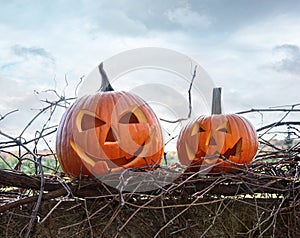 Funny face pumpkins sitting on fence