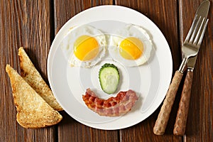 Funny face serving breakfast, fried egg