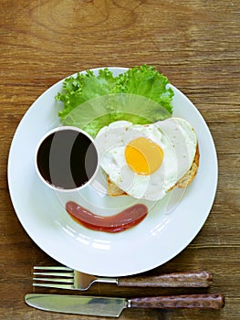 Funny face serving breakfast, fried egg, toast