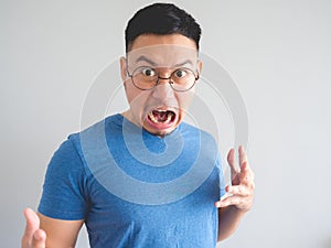 Funny face of shocked Asian man.