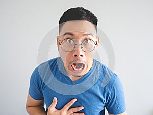 Funny face of shocked Asian man.