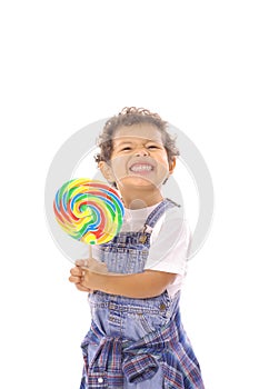 Funny face toddler with big lollipop