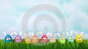 Funny faces colorful easter bunny eggs in a row on grass landcape for social media banners