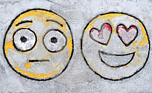 Funny faces emoticon on rough concrete background