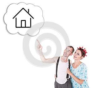 Funny family couple embracing and pointing on dream house