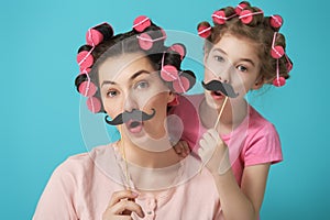 Mother and her daughter with a paper accessories