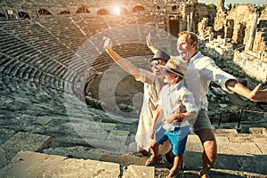 Funny family take a self photo in amphitheatre building.Side,Turkey