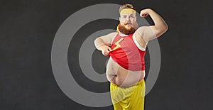 A funny fat man with a big belly shows the muscles on his arm.