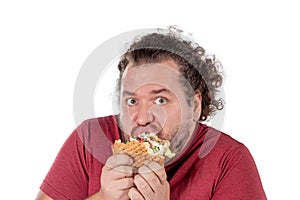 Funny fat man eating hamburger. Fast food, unhealty eat. Overweight and health problems