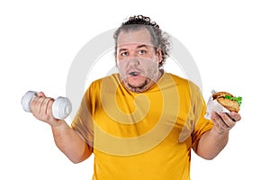 Funny fat man eating unhealthy food and trying to take exercise isolated on white background