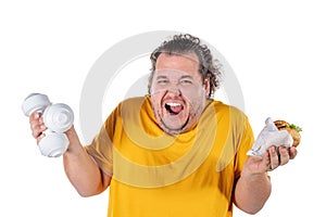 Funny fat man eating unhealthy food and trying to take exercise isolated on white background