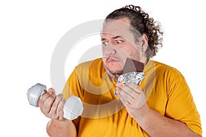 Funny fat man eating unhealthy food and trying to take exercise isolated on white background