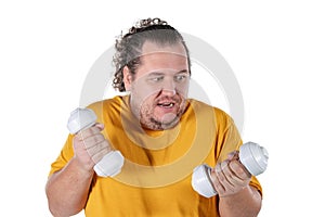 Funny fat man exercising with dumbbells and looking at camera isolated on white background