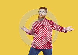 Funny fat man in polka dot shirt and glasses looks away with happy surprised face expression