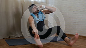 Funny fat man is trying to do yoga exercises on the rug. Brutal male yogi in tight clothes