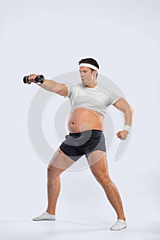 A funny fat man  on white background. Obesity and eating disorder. Concept for dietetics and fitness advertising