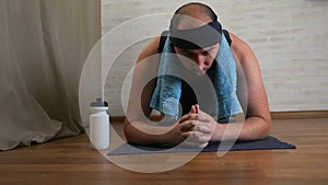 Funny fat man on yoga mat tired of classes, uses water, cools himself