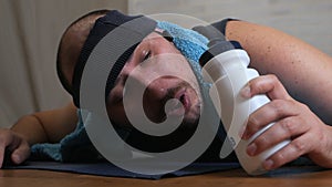 Funny fat man on yoga mat tired of classes, uses water, cools himself