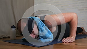 Funny fat man on yoga mat tired of classes, uses water, cools himself