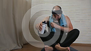 Funny fat man on yoga mat tired of classes, uses water, cools himself