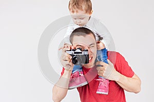 Funny father and child making selfie at vintage camera