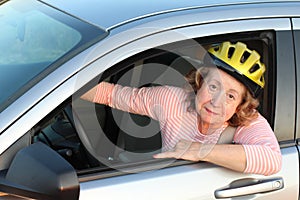 Funny female car driver wearing a helmet