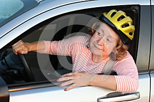 Funny female car driver wearing a helmet
