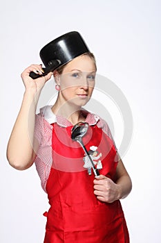 Funny female posing with saucepan on the head