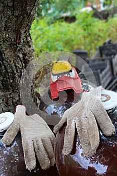 funny figure of gloves and cars with eyes and transparent bottles on a tree background