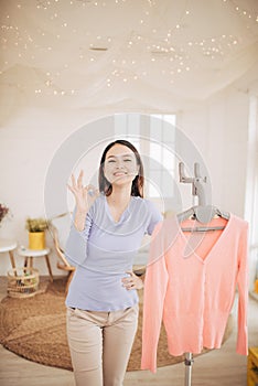 Funny foxy woman dancing with steamer iron. Housewife having fun while ironing clothes