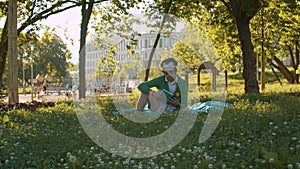 Funny freak man reading a book in the park