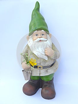 Funny garden gnome with a green cap