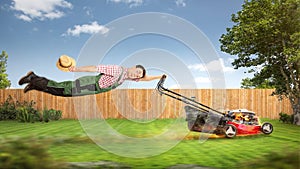 Funny gardener being pulled through the garden by a lawn mower photo