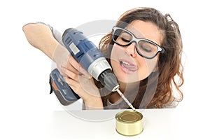 Funny geek girl trying to open a tin with a drill