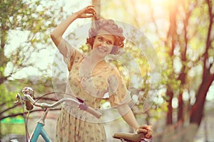 Funny girl on bicycle in spring park