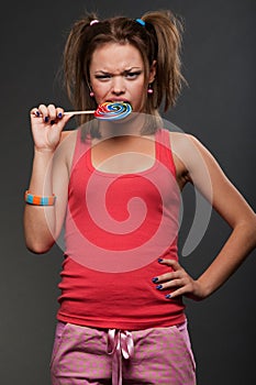 Funny girl bitting motley lollipop