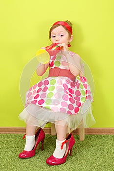 Funny girl in a bright dress and large