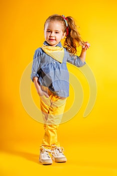 Funny girl on bright yellow background.