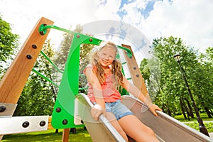 Funny girl on children chute ready to slide