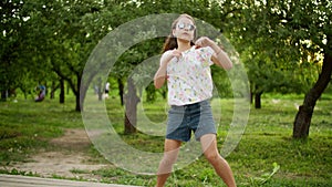 Funny girl dancing outdoors. Concentrated teen girl making rhythmical movements.